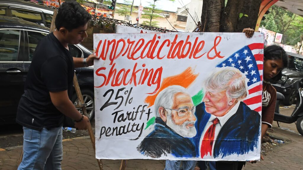 108181436-1754353236703-gettyimages-2227403808-AVaishnav_Students_from_Gurukul_school_of_art_paint_a_poster_on_25_tariff_imposed_by_USA_on_Ind.jpeg