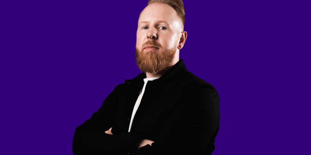 Toby-Headshot_blue-landscape-e1757081894130.png