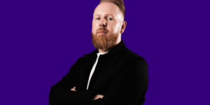 Toby-Headshot_blue-landscape-e1757081894130.png