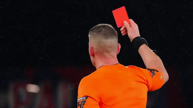 referee-holding-up-a-red-card-during-a-december-2024-soccer-game-in-london.jpg
