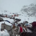 Rescuers run to reach hikers blocked